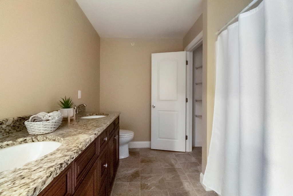 4 Sabrina Way, Unit H Feeding Hills, MA 01030 - Photo 27 of 34 a bathroom with a granite countertop sink and a mirror