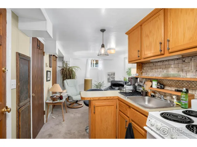 a living room with stainless steel appliances kitchen island granite countertop furniture and a view of kitchen