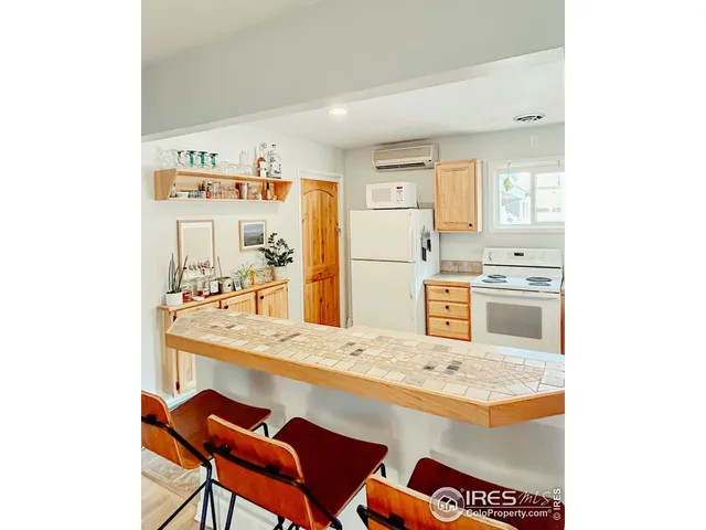 a kitchen with stainless steel appliances granite countertop a refrigerator and a stove