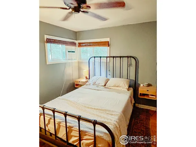 a bedroom with a bed and a television