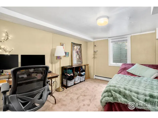 a bedroom with a bed a desk and chair