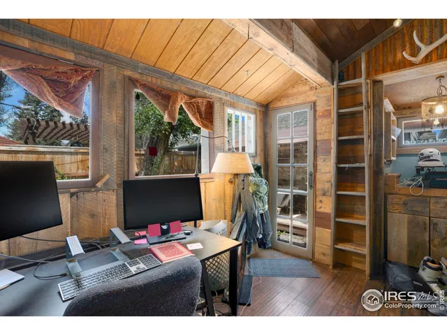 a backyard of a house with barbeque oven table and chairs