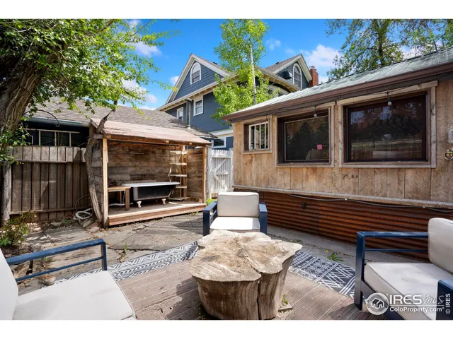 a view of a backyard with sitting area