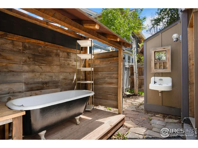 a backyard of a house with table and chairs