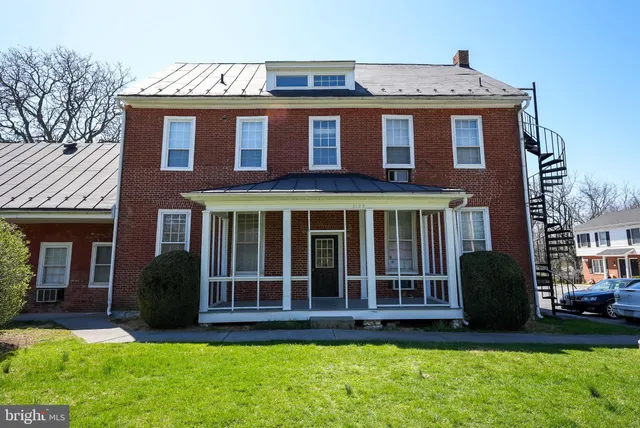 a view of a brick house with a large windows