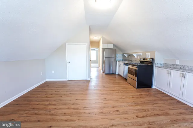 a view of a kitchen with wooden floor