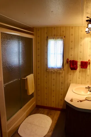 a bathroom with a sink toilet and shower