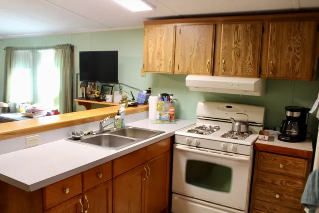 a kitchen with a sink stove and cabinets