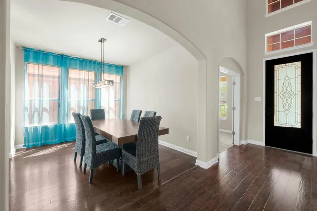 a view of a dining room with furniture and wooden floor