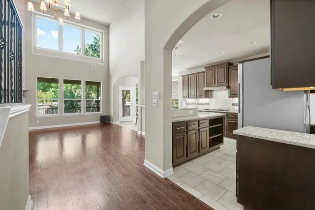 a kitchen with stainless steel appliances a stove top oven and a refrigerator
