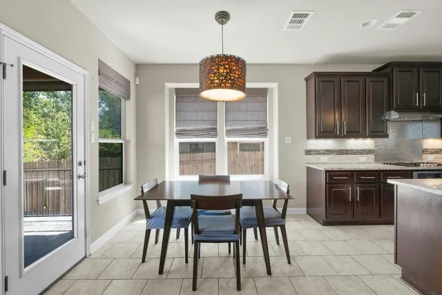 a dining room with furniture a chandelier and window