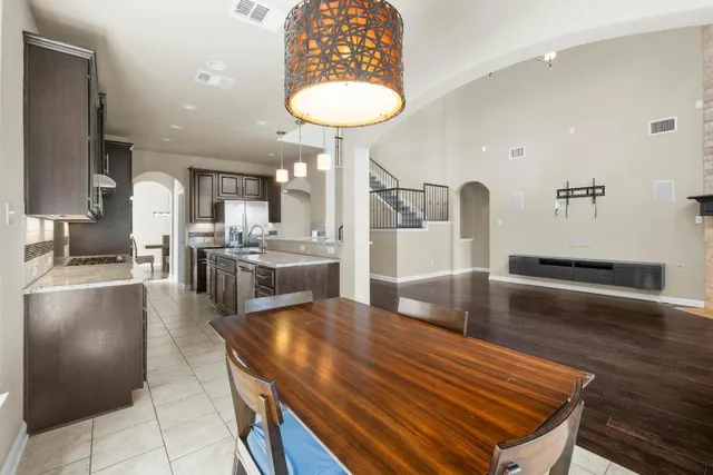 a kitchen with stainless steel appliances granite countertop a stove refrigerator and cabinets
