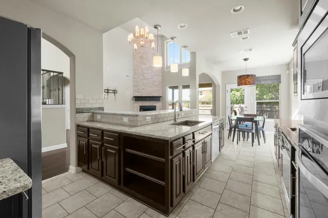 a kitchen with stainless steel appliances granite countertop a stove and a refrigerator