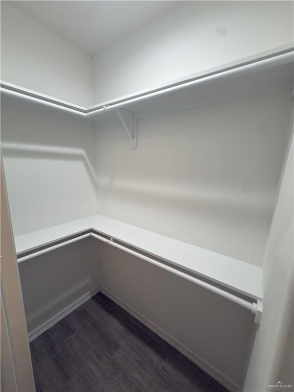 1619 Playa Drive, Unit 1 Weslaco, TX 78596 - Photo 11 of 11 a room with linen closet and wooden floor