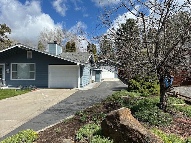 2188 Northeast Shepard Road Bend, OR 97701 - Photo 14 of 52 Attached garage adds convenience to this home with electric door opener, window, and man-door.