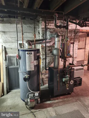 a room with water heater and a refrigerator