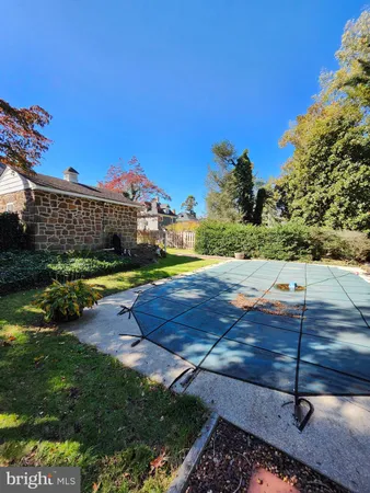 a view of a backyard with swimming pool