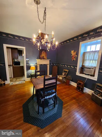 a living room with furniture a dining table and a chandelier