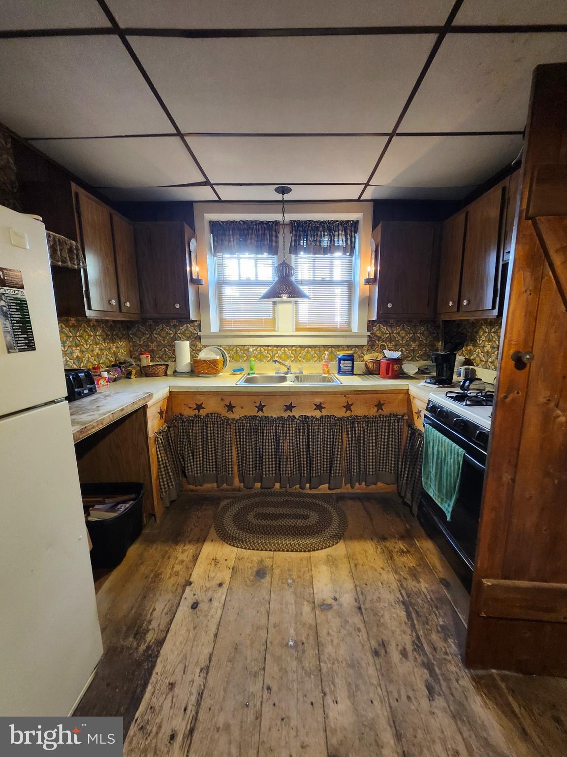 225 West Commerce Street Bridgeton, NJ 08302 - Photo 8 of 19 a kitchen with a sink a stove top oven a refrigerator and a dishwasher