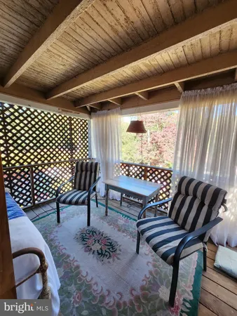 a outdoor living space with furniture and a rug