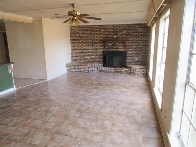 a view of empty room with a fireplace