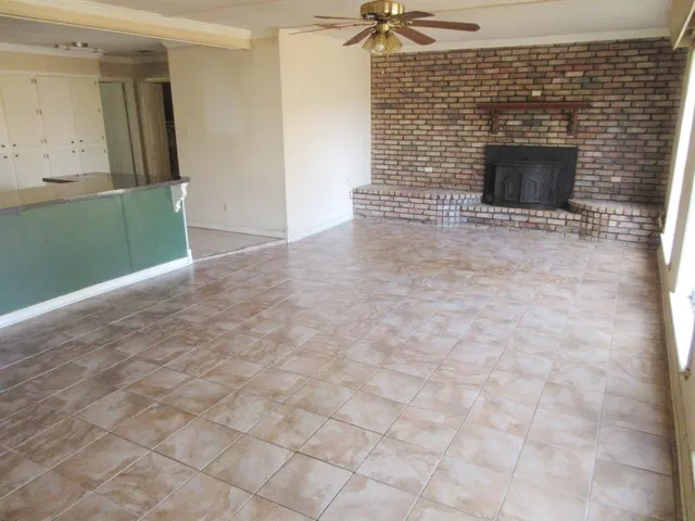 a view of an empty room with a fireplace