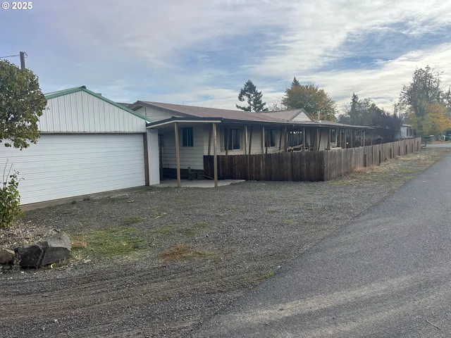 a view of a house with wooden fence