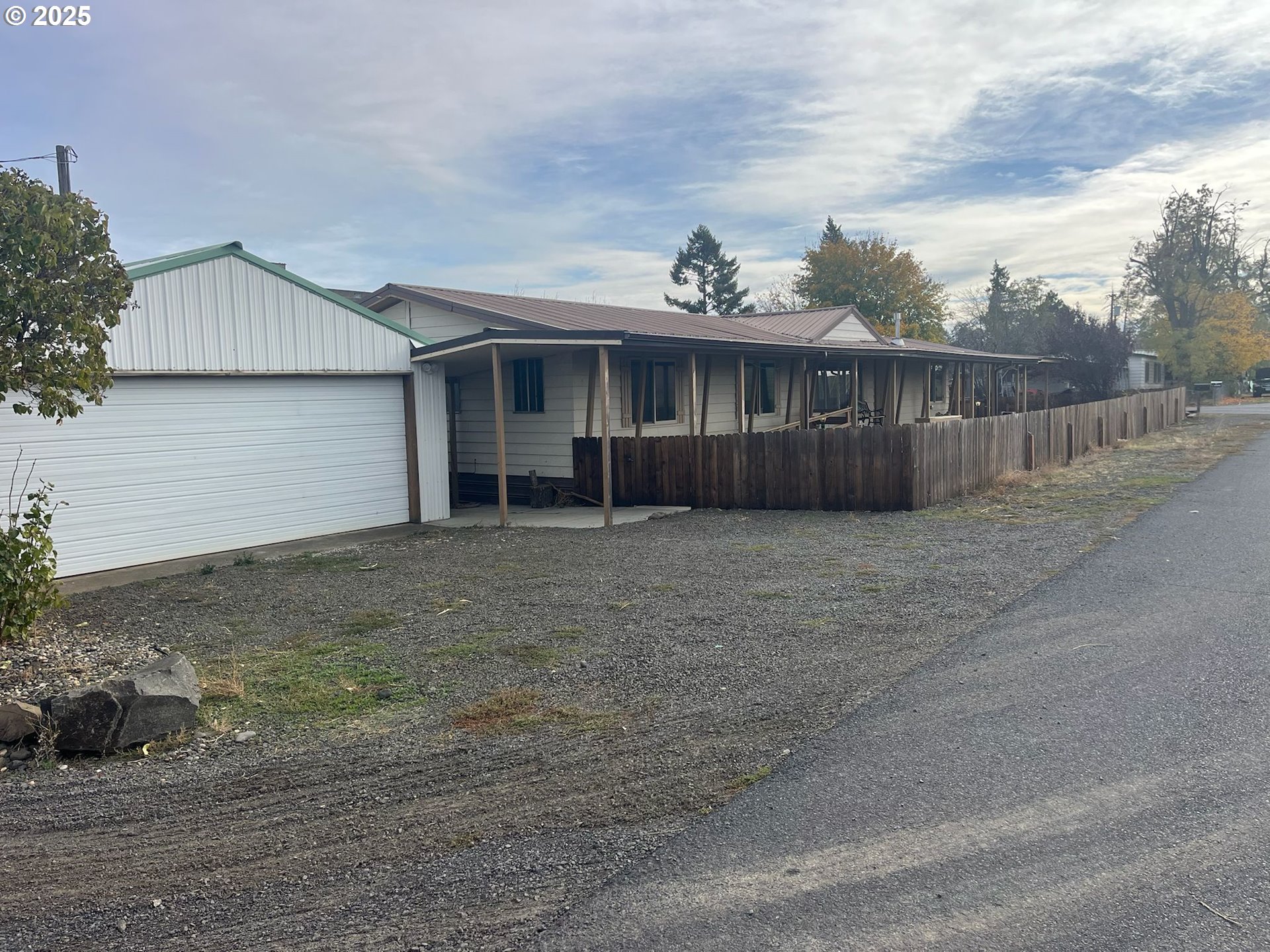 a view of a house with wooden fence