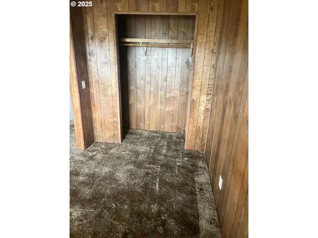 a bathroom with a granite countertop sink a toilet and a mirror