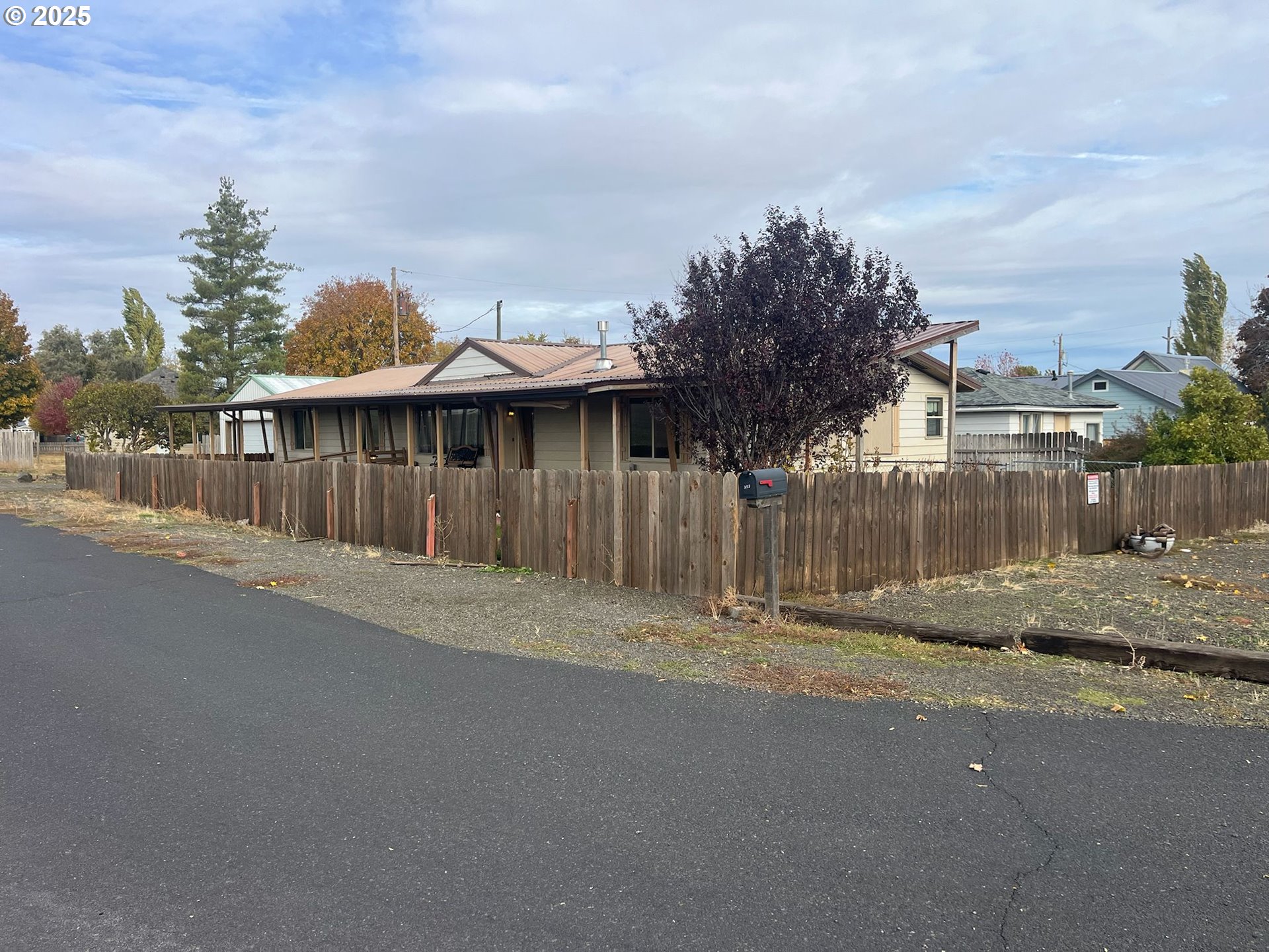355 West Washington Street Athena, OR 97813 - Photo 3 of 32 a view of a house with a yard and wooden fence