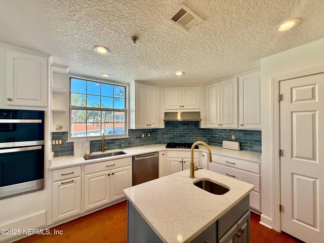 a kitchen with sink cabinets and window