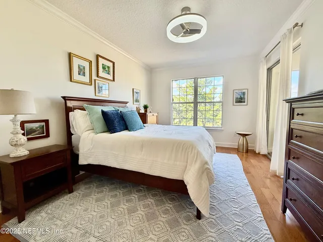 a bed room with a bed and a painting on the wall