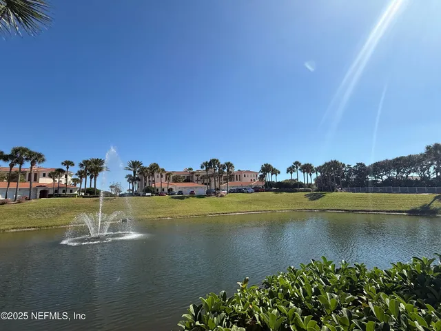 a view of a lake with houses in the back