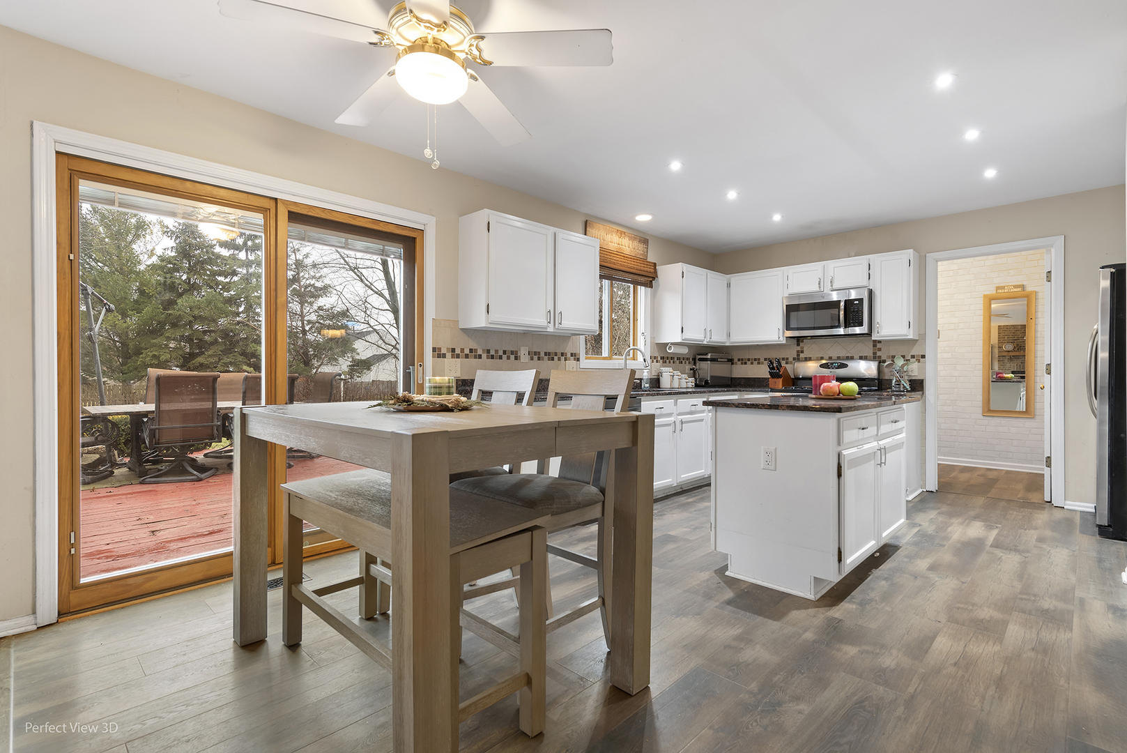 2001 Madison Avenue Gurnee, IL 60031 - Photo 7 of 26 a kitchen with stainless steel appliances granite countertop a stove top oven a refrigerator a sink and a dining table with garden view