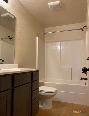 a bathroom with a sink mirror toilet and bathtub