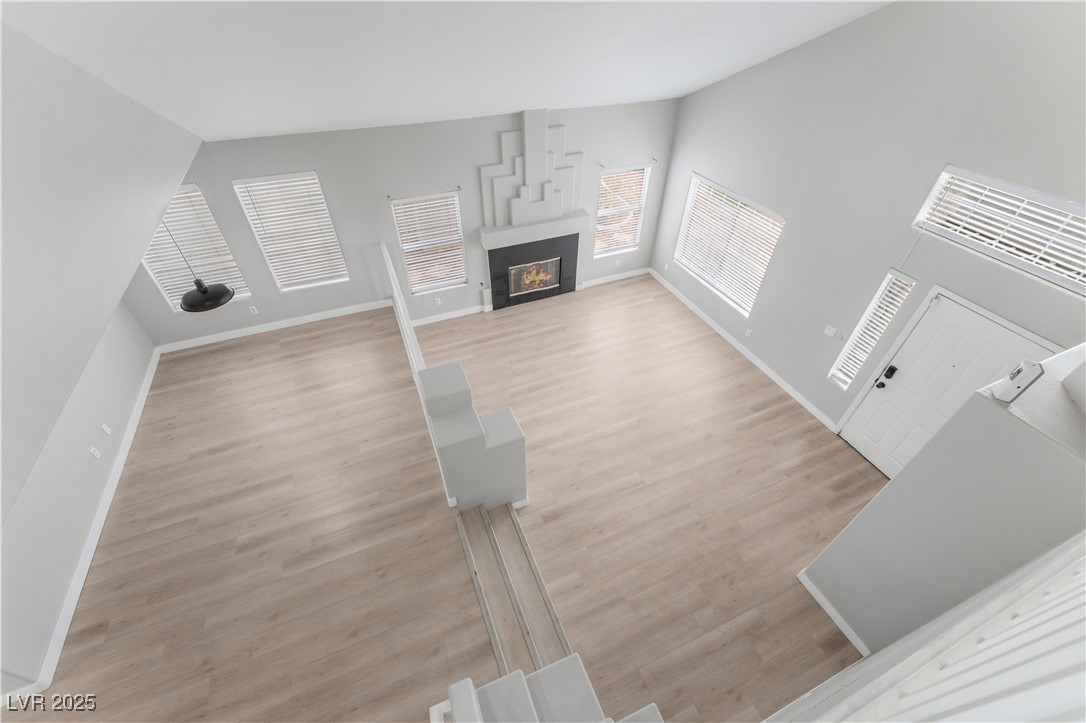 3695 Funston Way Las Vegas, NV 89129 - Photo 26 of 43 Unfurnished living room with light wood-style floors and a glass covered fireplace