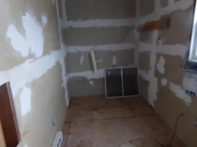 a view of a closet with wooden floor