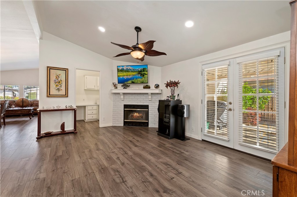 27250 Murrieta Road, Unit 120 Menifee, CA 92586 - Photo 13 of 46 a living room with furniture a fireplace and a flat screen tv