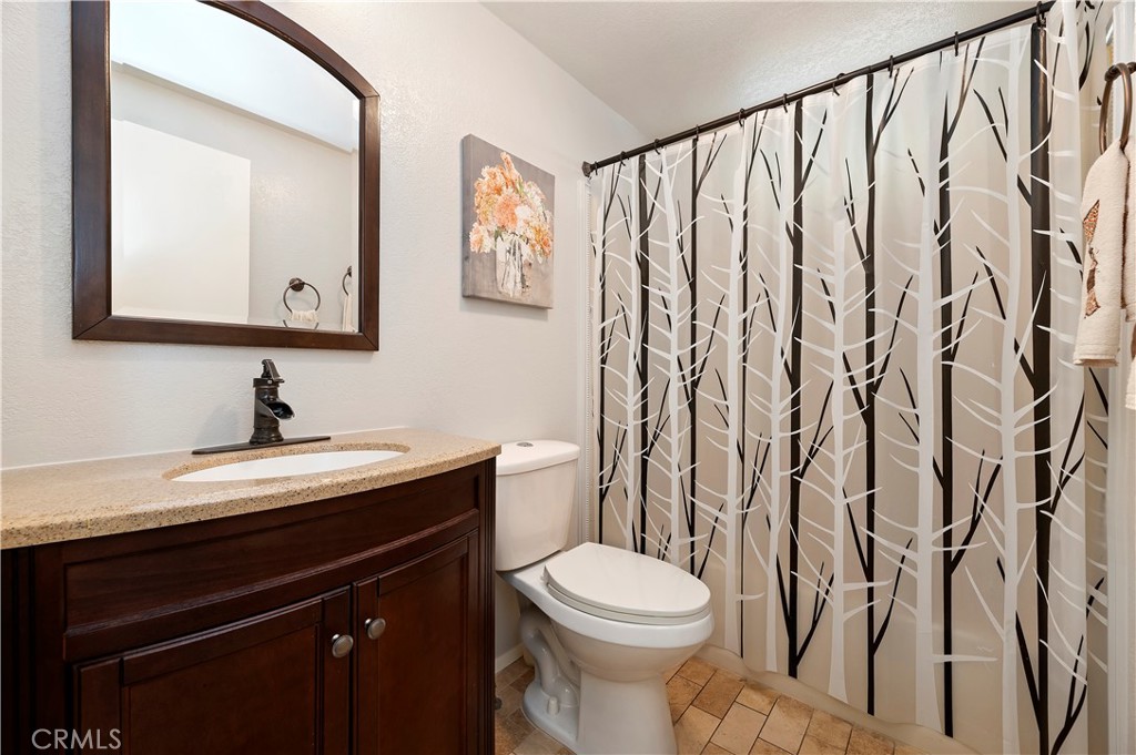 27250 Murrieta Road, Unit 120 Menifee, CA 92586 - Photo 25 of 46 a bathroom with a toilet sink and mirror