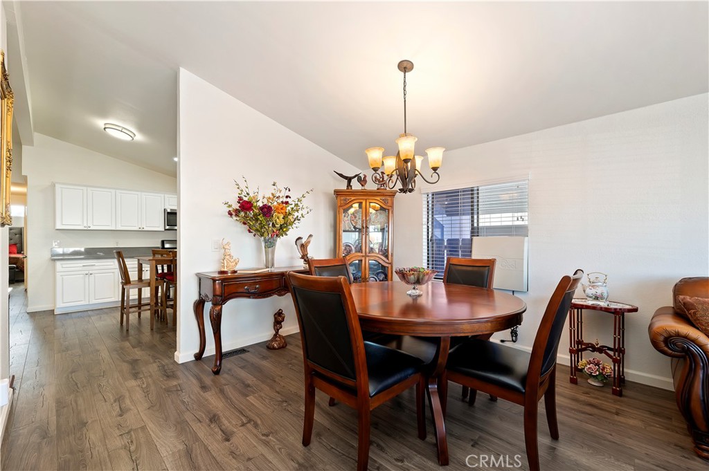 27250 Murrieta Road, Unit 120 Menifee, CA 92586 - Photo 10 of 46 a view of a dining room with furniture wooden floor and chandelier