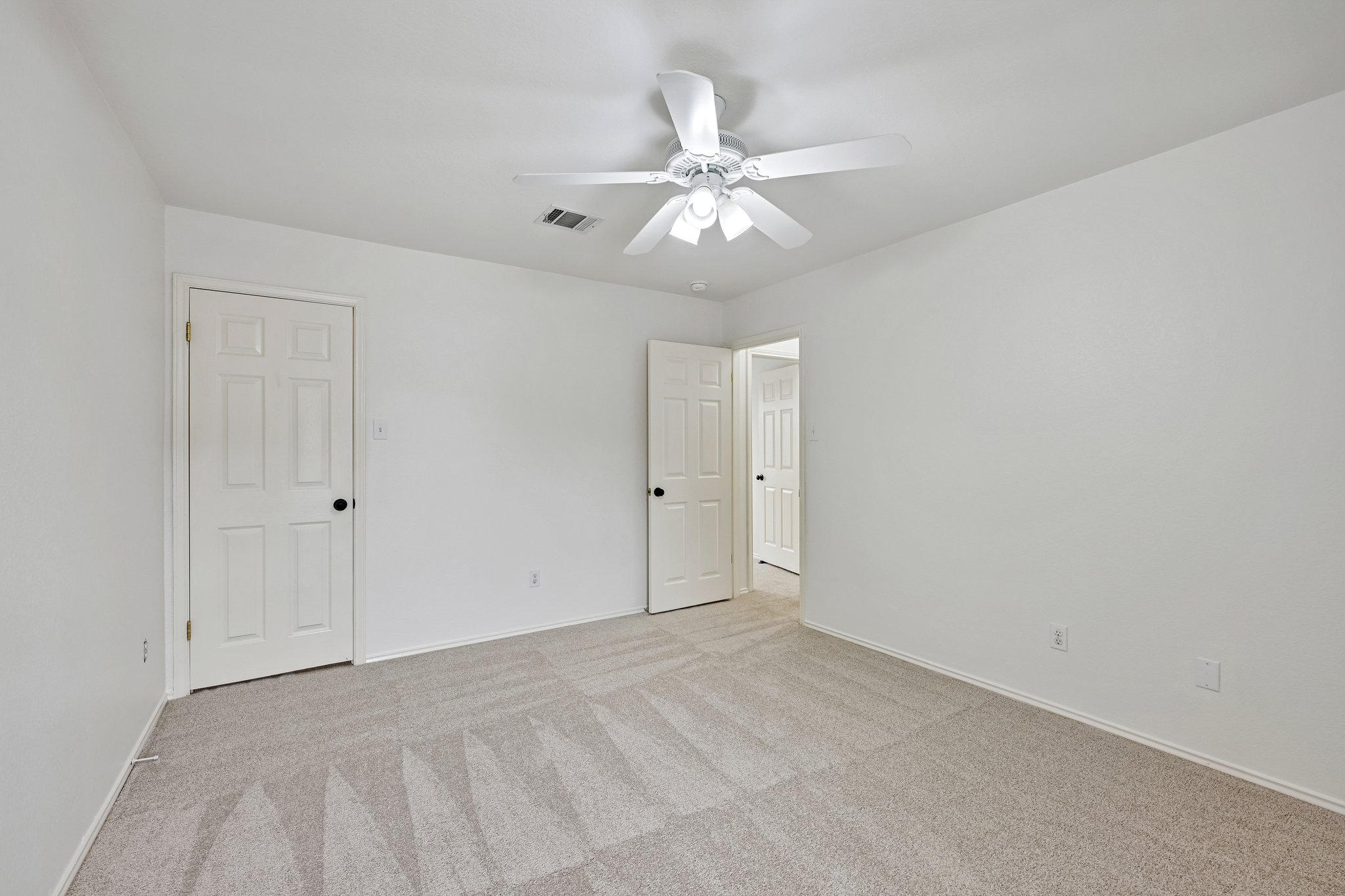 4100 Mocha Trail Austin, TX 78728 - Photo 20 of 33 A well-lit bedroom features plush carpeted flooring and a convenient ceiling fan.