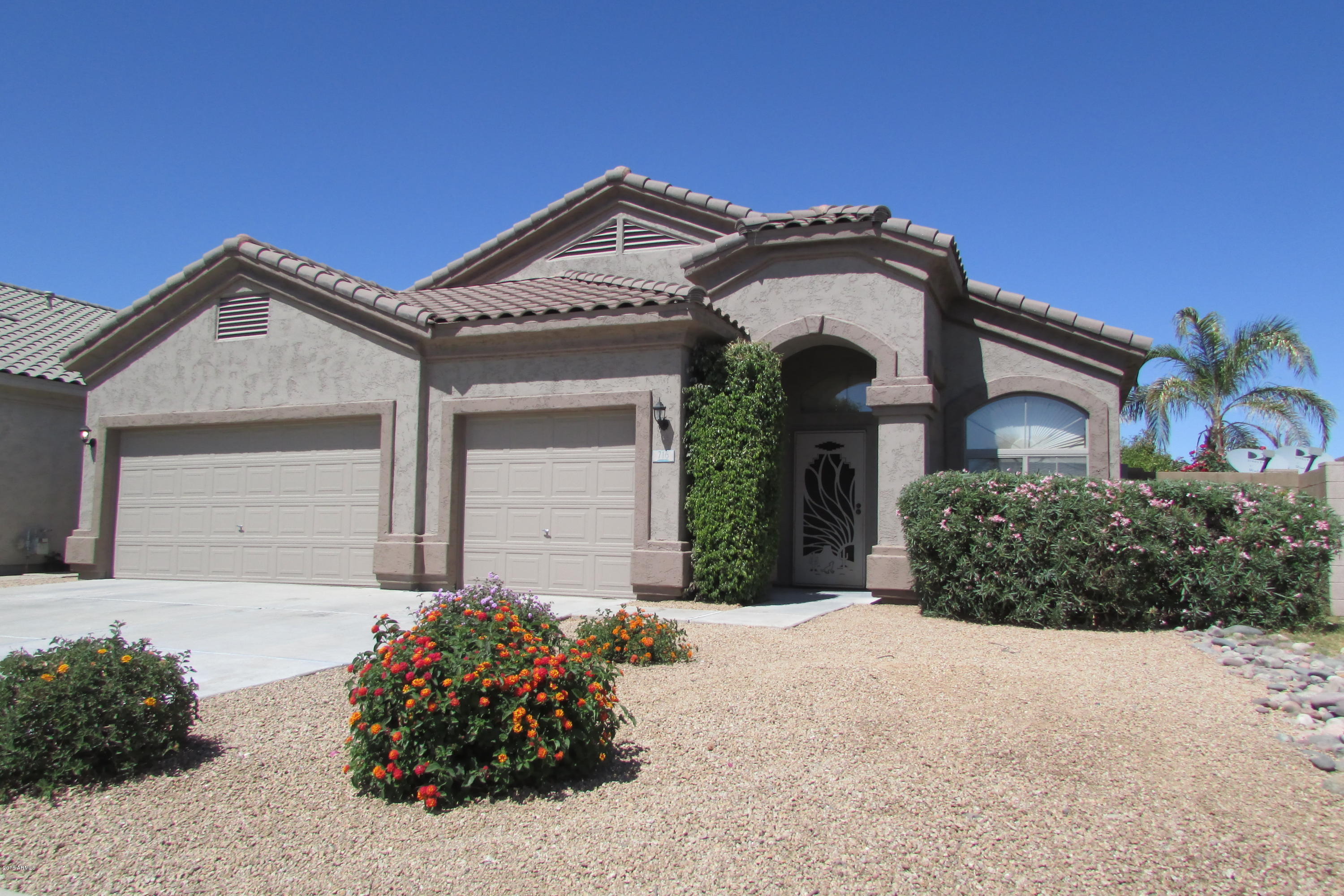 716 East Ranch Road Gilbert, AZ 85296 - Photo 2 of 22 a front view of a house with a yard