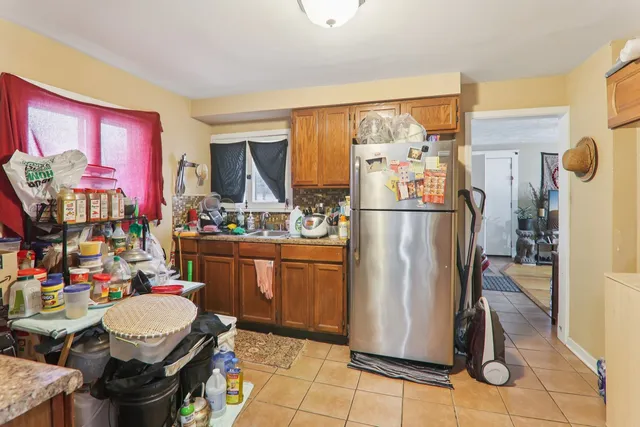 a kitchen with stainless steel appliances granite countertop a refrigerator and a stove