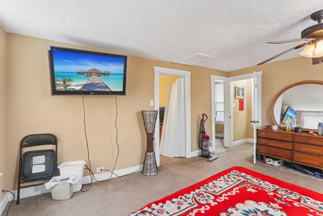 a view of an empty room with furniture and wooden floor