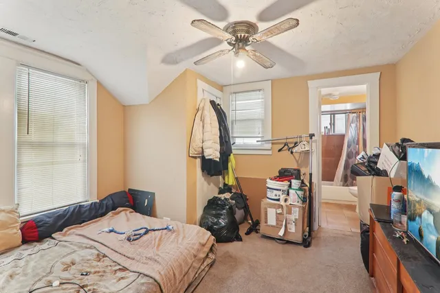 a bedroom with bed and a large mirror