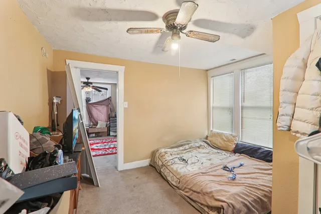 a bedroom that has a bed and a chandelier