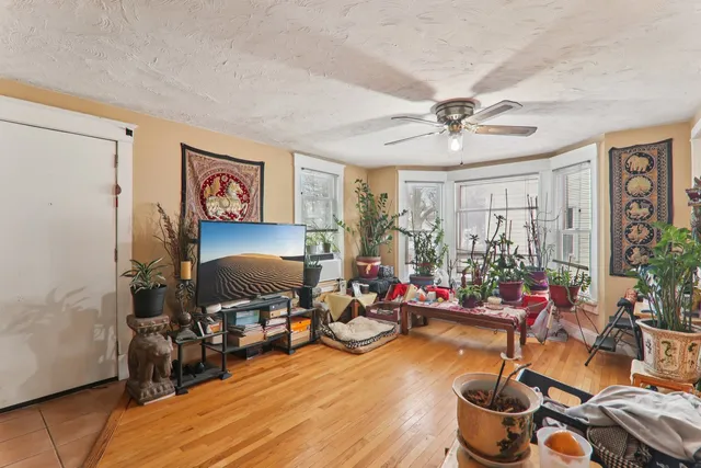 a living room with lots of furniture and paintings on the wall