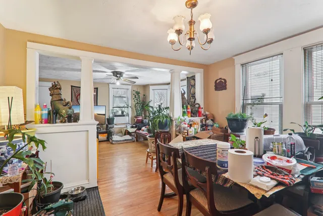 a view of a dining room with furniture window and wooden floor