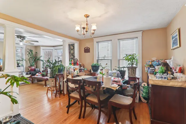 a view of a dining room with furniture window and wooden floor