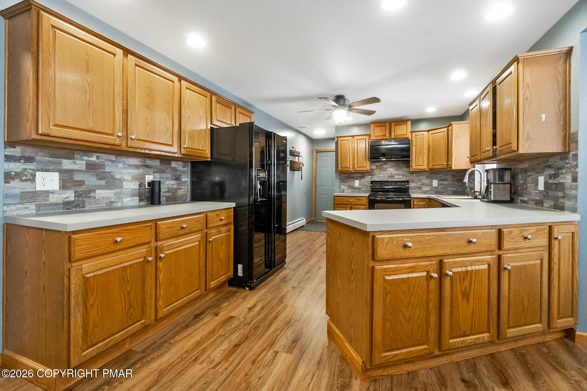 95 Benns Hill Road Bangor, PA 18013 - Photo 21 of 70 a kitchen with stainless steel appliances granite countertop a refrigerator a sink dishwasher a stove with wooden cabinets and floor